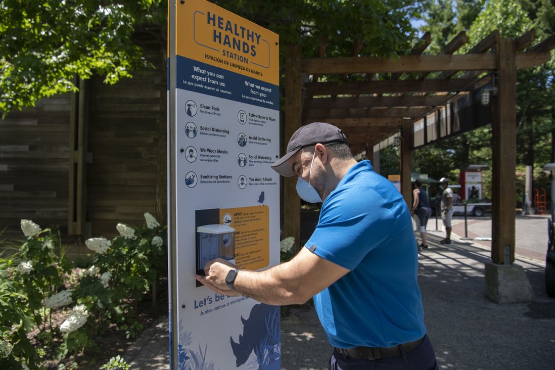Staff at a sanitizing station at the Bronx Zoo.